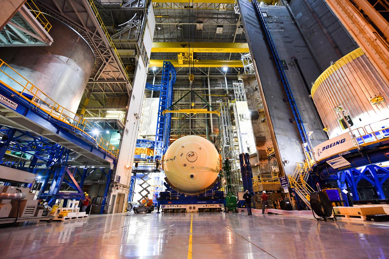 The Space Launch System (SLS) rocket’s liquid oxygen tank structural test article was manufactured and stacked in June 2019 at NASA’s Michoud Assembly Facility in New Orleans. To construct the test article, Boeing technicians at Michoud moved the liquid oxygen tank to the Vertical Assemby Building stacking and integration area. Here, they added simulators to mimic the two structures that connect to the tank, the intertank and the forward skirt.  This structural hardware for the SLS core stage for America’s new deep space rocket is structurally identical to the flight version of the tank. It will be shipped on the Pegasus barge to NASA’s Marshall Space Flight Center in Hunstville, Alabama, where it will undergo a series of tests that simulate the stresses and loads of liftoff and flight. These tests will help ensure designs are adequate for successful SLS missions to the Moon and beyond. The flight liquid oxygen tank along with the liquid hydrogen tank supplies more than 500,000 gallons of propellant to the core stages four RS-25 engines, which produce 2 million pounds of thrust to help send the SLS rocket to space.